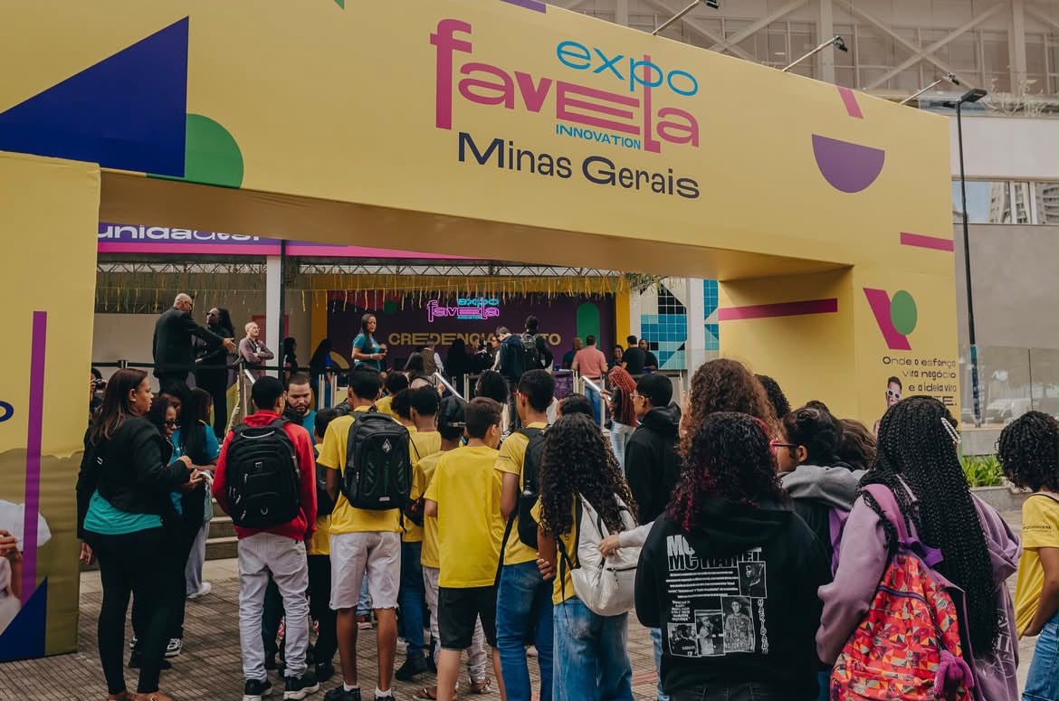 Espaço de entrada da Expo Favela Minas Gerais 2026, com várias pessoas entrando no evento.